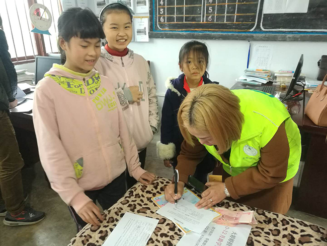 20171129志愿者杨俊见证李萍萍签收助学金.jpg